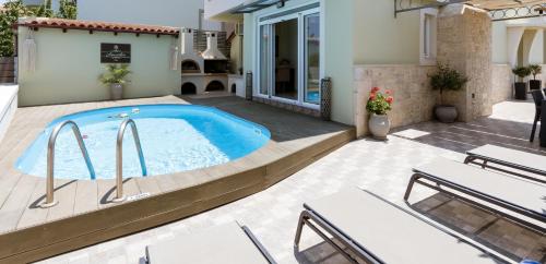 a swimming pool in the backyard of a house at Amarlia Villa in Skaleta