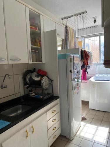 eine Küche mit einem weißen Kühlschrank und einer Spüle in der Unterkunft Hospedagem para temporada in Recife