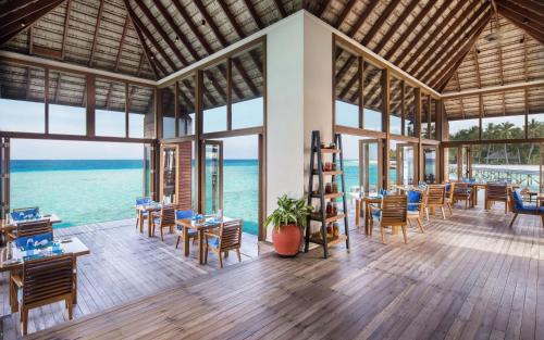 a restaurant with a view of the ocean at Conrad Maldives Rangali Island in Mandhoo