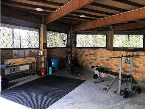 a room with a gym with weights and equipment at Sojourn at the Cove - opposite Heros Beach in North Arm Cove