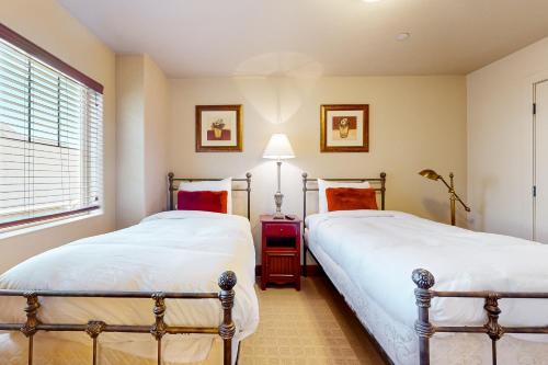 two twin beds in a bedroom with a window at Relaxed on Redstone in Park City