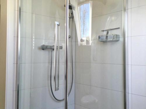 a shower with a glass door in a bathroom at Ferienwohnung Le Papillon in Kröslin