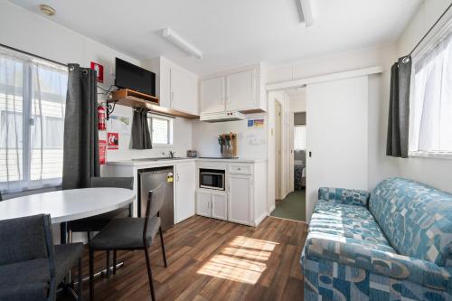 a living room with a couch and a table at Bright Accommodation Park in Bright