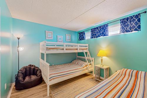 a bedroom with two bunk beds and a lamp at Wight Bay North #439 in Ocean City