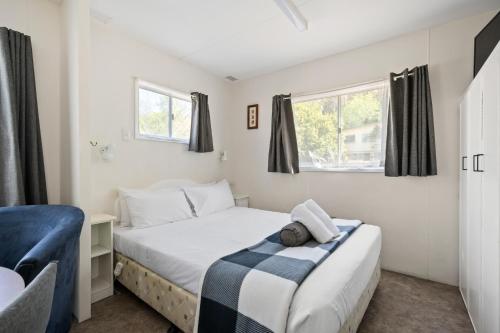 a bedroom with two beds and a window at Bright Accommodation Park in Bright