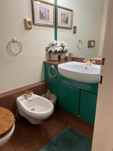 a bathroom with a white toilet and a sink at Sweet Campiglio in Madonna di Campiglio