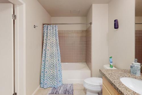 a bathroom with a tub and a toilet and a sink at The Heart of the City in San Diego