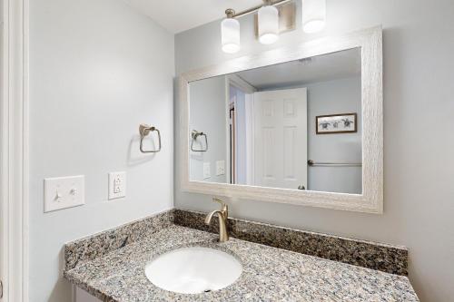 a bathroom with a sink and a mirror at Phoenix IV 4052 in Orange Beach