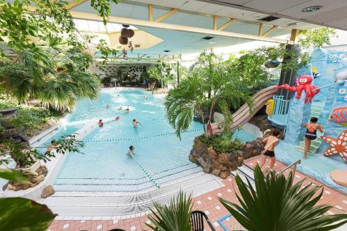 ein Schwimmbad in einem Einkaufszentrum mit Leuten darin in der Unterkunft Center Parcs Limburgse Peel Limburg-Brabant in America