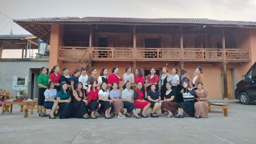 a group of people posing for a picture in front of a building at Diềm Bungalow in Ha Giang