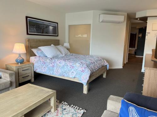 a bedroom with a bed and a living room at Waves 348 - Free WiFi - Late CheckOut - Garage in Cowes