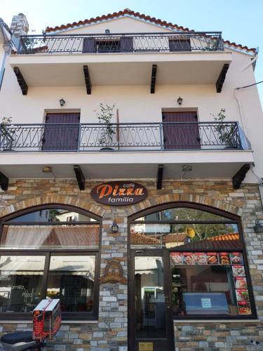 a building with a sign for a pizza joint at Marousos Central Guesthouse in Portariá