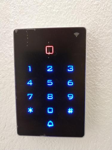 an electronic clock with blue lights on a wall at Marousos Central Guesthouse in Portariá