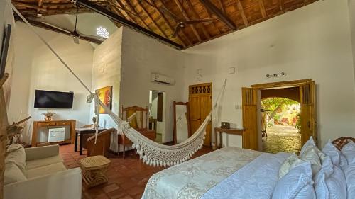 a bedroom with a hammock in a room at Hotel Boutique Casa de Los Santos Reyes Valledupar in Valledupar