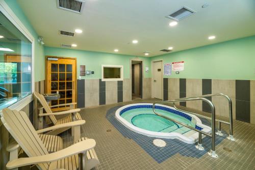 a spa room with a hot tub and chairs at Comfort Inn & Suites in Terrace