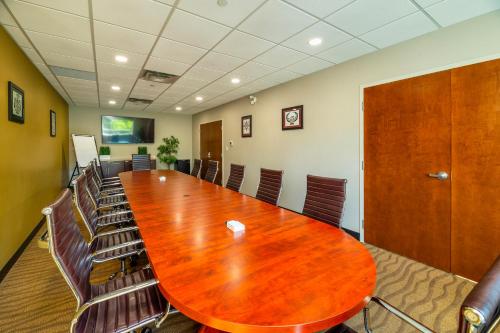 a conference room with a large wooden table and chairs at Comfort Inn & Suites in Terrace