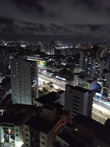 a view of a city at night with buildings at Apartamento encantador no bairro da pituba. in Salvador