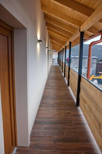 a hallway of a house with wooden floors and a wooden ceiling at Penzion pod Hazmburkem in Klapý
