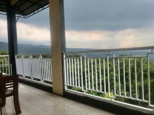 a balcony with a view of the ocean at Munduk Sena in Munduk
