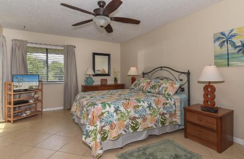 a bedroom with a bed and a ceiling fan at Beautifully updated Sea Woods Condo near main pool and beach access - SC248 in Edgewater