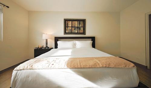 a bedroom with a large white bed in it at Tumon Isa 16 Condo in Tamuning