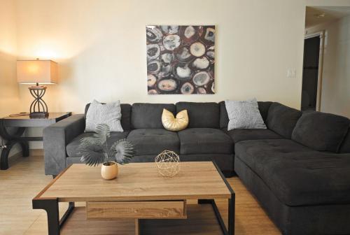 a living room with a couch and a coffee table at Tumon Isa 16 Condo in Tamuning