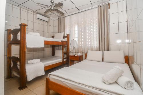 a bedroom with two bunk beds and a desk at Hotel Aldea Chorotega Puntarenas in Puntarenas