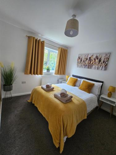 a bedroom with a large bed with towels on it at One Bed Apartment Stevenage in Stevenage