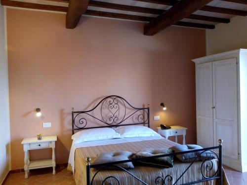 a bedroom with a bed and two night stands at Tenuta Del Perugino in Bettona