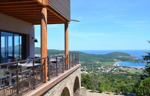 a balcony of a house with a view of the ocean at Le Tomino in Macinaggio