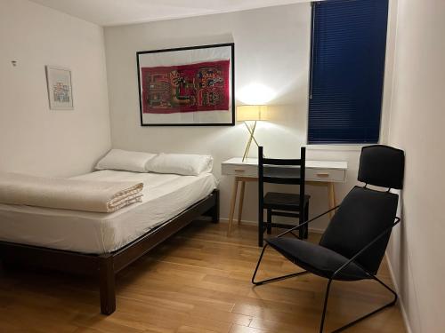 a bedroom with a bed and a desk and a chair at No-taking-reservations in London