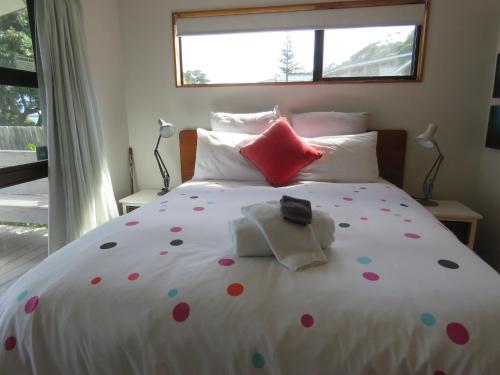 a bedroom with a large bed with polka dots on it at Rangiputa Moana in Karikari Peninsula