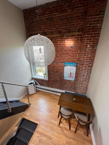 a dining room with a table and a brick wall at Affordable & Chic RiNo/LoDo/Dtown Loft- Walkable in Denver