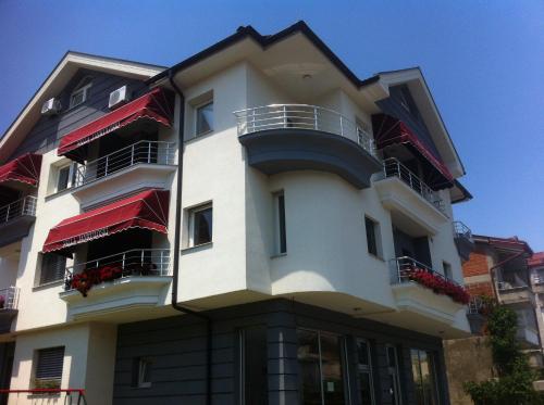 a tall white building with balconies and windows at Villa Jankuloski in Ohrid