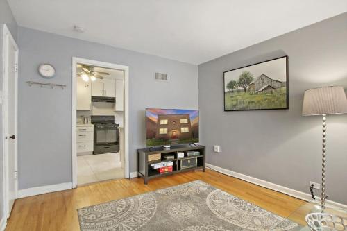 sala de estar con mesa y TV en la pared en Condo by the park & lake in the heart of Evanston!, en Evanston