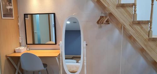 a bathroom with a vanity and a mirror and a desk at JSM Studio Hongdae in Seoul