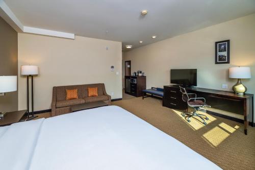 a large hotel room with a bed and a desk at Comfort Inn & Suites in Terrace