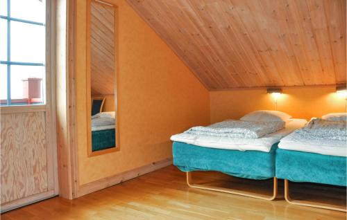 two beds in a small room with a mirror at Lovely Apartment In Slen With House A Panoramic View in Sälen