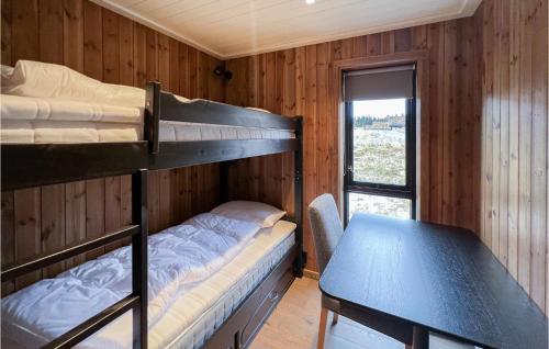 a room with two bunk beds and a table at Cozy Home In Sjusjen With Kitchen in Sjusjøen