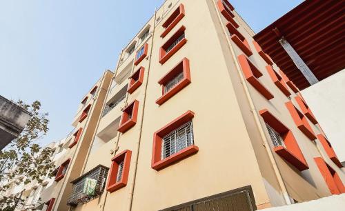 a tall building with red windows on it at Flagship Hotel Creation Premium in Sānkchi