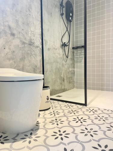 a bathroom with a shower and a toilet in it at Attitude Resort Langkawi in Pantai Cenang