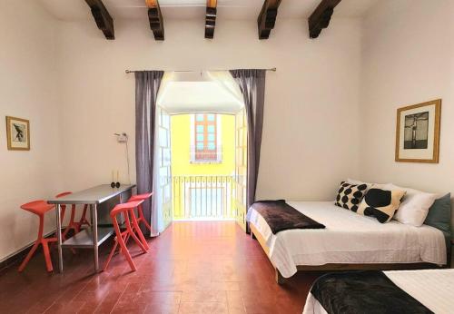 a bedroom with a bed and a desk and a table at Cómoda Habitación con Baño en Pasillo in Querétaro