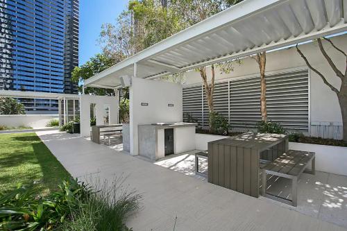 a patio with a table and a grill at H-Residences Private Apartments - Hosted by Coastal Letting in Gold Coast