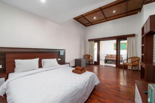 a bedroom with a large bed with a teddy bear on it at Villa Taurus in Seminyak