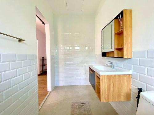 a white bathroom with a sink and a mirror at Brand New Home in Cebu City with 3 Large Bedrooms! in Cebu City