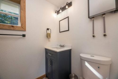 a bathroom with a white toilet and a sink at Relaxing Lakeside Retreat in Rhinelander