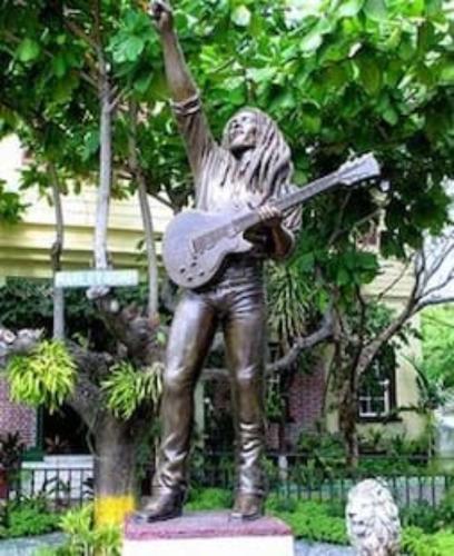 a statue of a man holding a guitar at Elegant & Stylish 2BR New Kingston in Kingston