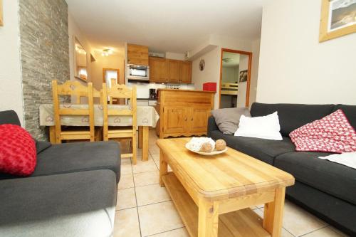 a living room with two couches and a table at Résidence Chalet d'Or by Leavetown Vacations in Les Deux Alpes