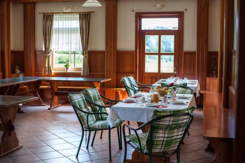 a dining room with a table and chairs and a table and chairsktop at Farm Stay Kramer in Bistrica ob Sotli