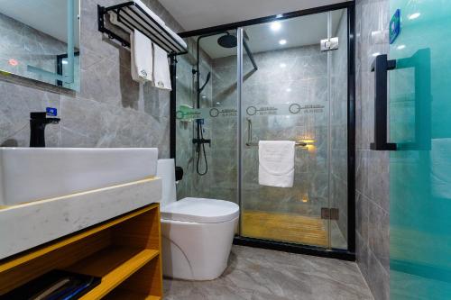 a bathroom with a shower and a toilet and a sink at Amemouillage Inn - Guangzhou Railway Station Xicun Metro Station in Guangzhou